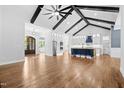 Open-concept living space featuring wood floors, exposed beams, and a modern kitchen at 1903 Edgerton Dr, Durham, NC 27703