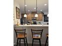Eat-in kitchen bar area with pendant lighting and stainless steel appliances at 204 Plank Bridge Way, Morrisville, NC 27560
