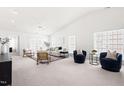 Spacious living room featuring neutral decor, ample natural light, comfortable seating, and vaulted ceilings at 210 Millet Dr, Morrisville, NC 27560