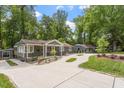 Sprawling property featuring a long driveway and lush landscaping, providing serene curb appeal at 2114 Woodview Dr, Raleigh, NC 27604