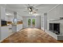 Inviting living room boasts a fireplace, built-in shelving, and beautiful hardwood floors, open to the kitchen at 213 Old Mallard Rd, Smithfield, NC 27577