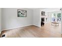 Open-concept space with wood floors, fireplace, and view of another room at 2169 Rawls Church Rd, Angier, NC 27501