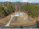 Aerial view of a charming home with a large yard, long driveway, and a shed in the back at 226 Fletcher Ridge Rd, Timberlake, NC 27583