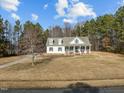Beautiful home with a sprawling front lawn, surrounded by mature trees at 226 Fletcher Ridge Rd, Timberlake, NC 27583