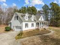 Charming home featuring a front porch, two-car garage, and well-maintained landscaping at 226 Fletcher Ridge Rd, Timberlake, NC 27583