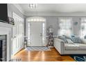 Inviting living room featuring a decorative fireplace, gleaming hardwood floors, and natural light at 226 Fletcher Ridge Rd, Timberlake, NC 27583