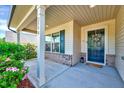 Inviting front porch with decorative wreath, lush plantings, and brick accents at 2540 Averon Dr, Fuquay Varina, NC 27526
