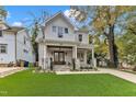 Charming two-story home featuring a welcoming front porch, manicured lawn, and beautiful stone accents at 2615 Bedford Ave, Raleigh, NC 27607