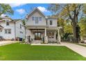 Charming two-story home featuring a welcoming front porch, manicured lawn, and beautiful stone accents at 2615 Bedford Ave, Raleigh, NC 27607