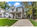 Charming two-story home featuring a welcoming front porch, manicured lawn, and beautiful stone accents at 2615 Bedford Ave, Raleigh, NC 27607