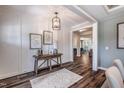 Elegant entryway featuring hardwood floors, wainscoting, a rustic console table, and decorative artwork at 269 Ivy Ridge Rd, Chapel Hill, NC 27516