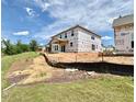 Rear exterior view of a new construction home featuring windows and unfinished yard at 27 Spring Crest Dr # 69, Angier, NC 27501
