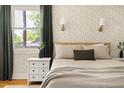 Cozy bedroom with stylish wallpaper, bedside tables, and natural light from the window at 2702 Richwood Rd, Durham, NC 27705