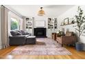Inviting living room with hardwood floors, built-in bookshelves and a cozy fireplace at 2702 Richwood Rd, Durham, NC 27705