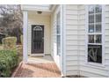 Inviting entryway with brick walkway, decorative front door, and sidelight window at 2728 Cherry Field Dr, Raleigh, NC 27603
