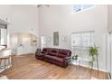 Bright living room with high ceilings, hardwood floors, and a large window at 2728 Cherry Field Dr, Raleigh, NC 27603
