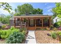 Inviting home with a covered porch, attractive landscaping, and a walkway leading to the front door at 2811 Van Dyke Ave, Raleigh, NC 27607