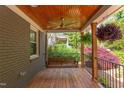 Relaxing covered porch with wood ceiling, a swing, and space for outdoor lounging at 2811 Van Dyke Ave, Raleigh, NC 27607