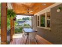 Outdoor living space: a covered porch with wood ceiling, fan, and a table with seating at 2811 Van Dyke Ave, Raleigh, NC 27607