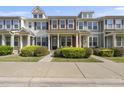 Charming townhome featuring colorful shutters, a covered porch, and lovely front yard landscaping at 2821 Wilshire Hill Dr # 111, Raleigh, NC 27604