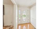 Bright foyer with hardwood floors, decorative wallpaper and front door with sidelights at 3011 Old Hillsborough Rd, Mebane, NC 27302