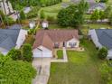 Aerial view of a cozy home with a well-kept lawn, mature trees, and a two-car garage at 308 Holly Briar Dr, Fuquay Varina, NC 27526