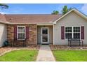 Inviting front entrance featuring stone accents, benches, and a well-maintained walkway at 308 Holly Briar Dr, Fuquay Varina, NC 27526