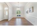 Bright dining room with hardwood floors, an arched window, and wainscoting for an elegant look at 315 Copper Ridge Dr, Sanford, NC 27330