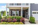 Inviting entryway with a stylish front door, stone accents, and well-manicured landscaping at 316 Barley Mill Rd, Holly Springs, NC 27540