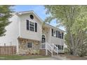 Two-story home with stone accents and black shutters with a walkway up to the front door at 3613 Ranbir Dr, Durham, NC 27713