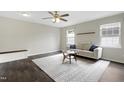 Bright living room featuring hardwood floors, neutral walls, and a cozy seating area at 3613 Ranbir Dr, Durham, NC 27713