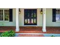 Elegant front entrance with a beautiful black double door and brick porch at 3804 Nottaway Rd, Durham, NC 27707