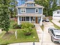 Two-story home with a inviting front porch, a driveway, and lush landscaping at 408 Jerome Rd, Durham, NC 27713