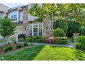 Beautiful exterior of a home featuring lush landscaping, a stone facade, and a well-manicured lawn at 419 Travertine Dr, Cary, NC 27519
