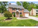 Classic brick home with lush landscaping and a welcoming front entrance at 4704 Lancashire Dr, Raleigh, NC 27613