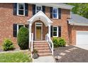 Inviting front entrance with brick steps and a charming covered porch at 4704 Lancashire Dr, Raleigh, NC 27613