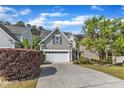 Charming two-story home featuring a two-car garage, manicured lawn, and mature landscaping at 4727 Smarty Jones Dr, Knightdale, NC 27545