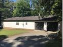 Two-car garage with a concrete driveway and well-maintained exterior at 5002 Wickham Rd, Raleigh, NC 27606