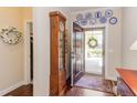 Inviting foyer with hardwood floors, decorative plates, and a view of the front yard at 5144 Niagra Dr, Chapel Hill, NC 27517