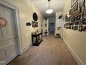 Inviting foyer with carpet flooring, complemented by Gathering photos and a decorative table at 515 E Woodall St, Smithfield, NC 27577