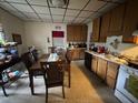 Functional kitchen with wooden cabinets, dining table, and linoleum flooring at 515 E Woodall St, Smithfield, NC 27577