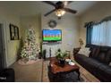 Cozy living room showcasing a comfortable leather sofa, television and natural light at 515 E Woodall St, Smithfield, NC 27577
