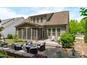 Relaxing backyard with screened porch, patio, fire pit, and outdoor seating area at 525 Morning Oaks Dr, Holly Springs, NC 27540