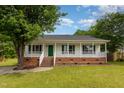 Charming single-story home with a welcoming front porch and manicured lawn at 5317 Cottage Bluff Ln, Knightdale, NC 27545