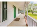 Inviting front porch featuring a green front door, and white railing at 5317 Cottage Bluff Ln, Knightdale, NC 27545