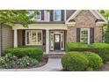Inviting front entrance with lush landscaping and classic architectural details at 5705 at 5705 Tannibark Ln, Fuquay Varina, NC 27526