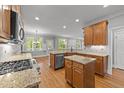 Bright, updated kitchen with stainless appliances, granite countertops and open floorplan at 5705 Tannibark Ln, Fuquay Varina, NC 27526