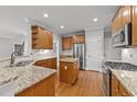 Spacious kitchen with granite countertops, stainless steel appliances, and a center island at 5705 Tannibark Ln, Fuquay Varina, NC 27526