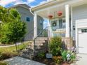 Charming home featuring a welcoming porch, brick stairs, and beautifully landscaped front yard at 636 Copper Beech Ln, Wake Forest, NC 27587