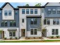 Modern townhome featuring gray and white siding, and a landscaped front yard at 6416 Tanner Oak Ln, Raleigh, NC 27613